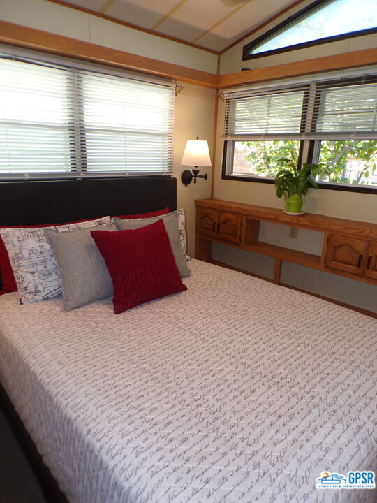 69801 Ramon Road, Unit 246 Cathedral City, CA 92234 - Photo 9 of 44 a bedroom with a large bed and a large window