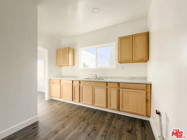 a view of a kitchen with wooden floor and cabinet