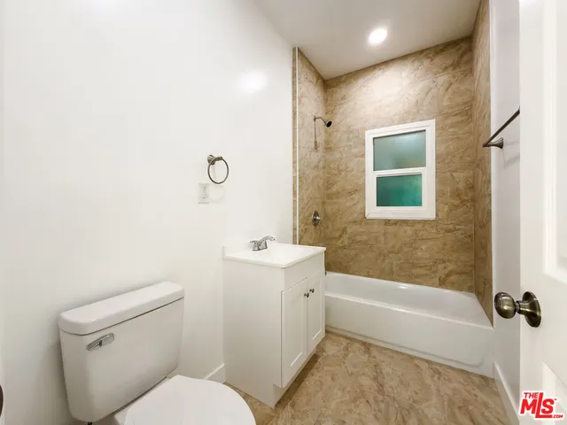 a bathroom with a toilet a sink and bathtub