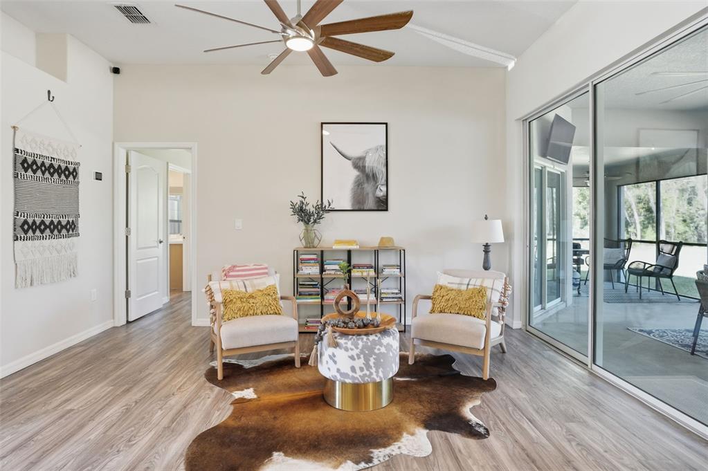 18166 Ramsey Road Weeki Wachee, FL 34614 - Photo 24 of 57 a living room with furniture and a wooden floor