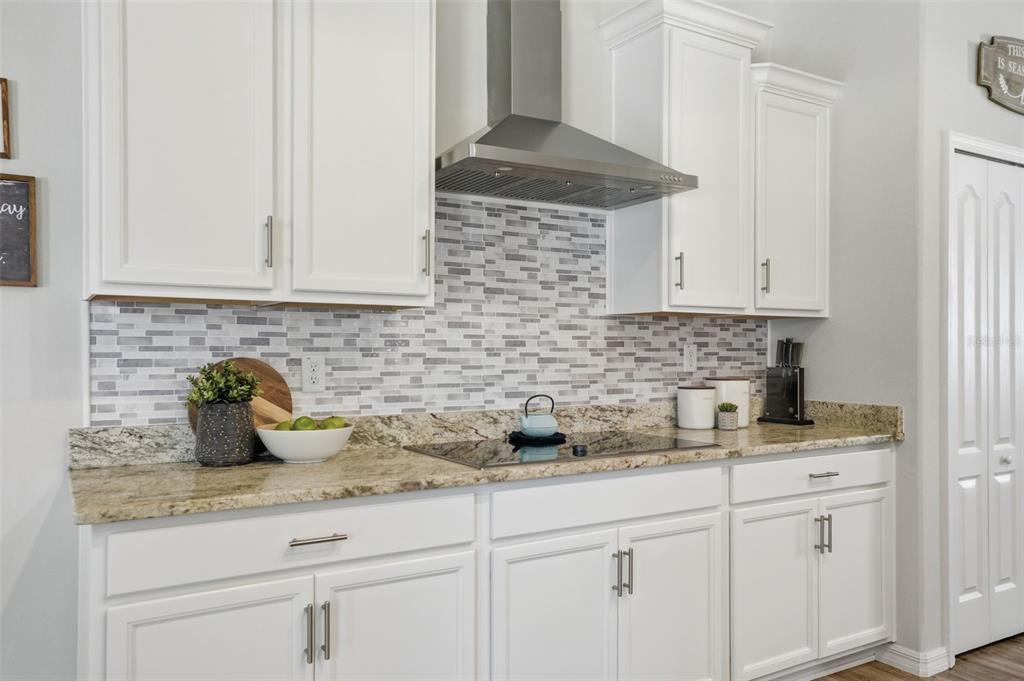 18166 Ramsey Road Weeki Wachee, FL 34614 - Photo 26 of 57 a kitchen with white cabinets and a sink