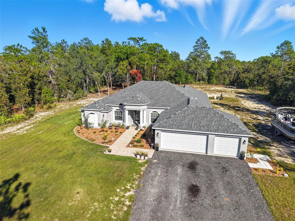 18166 Ramsey Road Weeki Wachee, FL 34614 - Photo 45 of 57 a view of a house with a yard