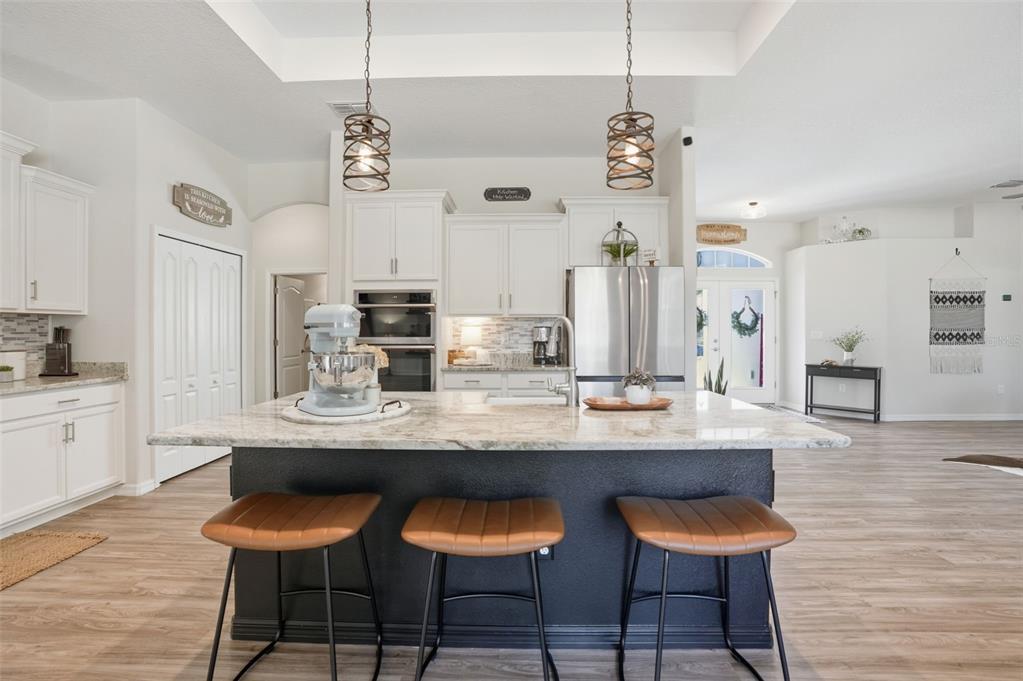 18166 Ramsey Road Weeki Wachee, FL 34614 - Photo 5 of 57 a dining room filled chandelier and wooden floor