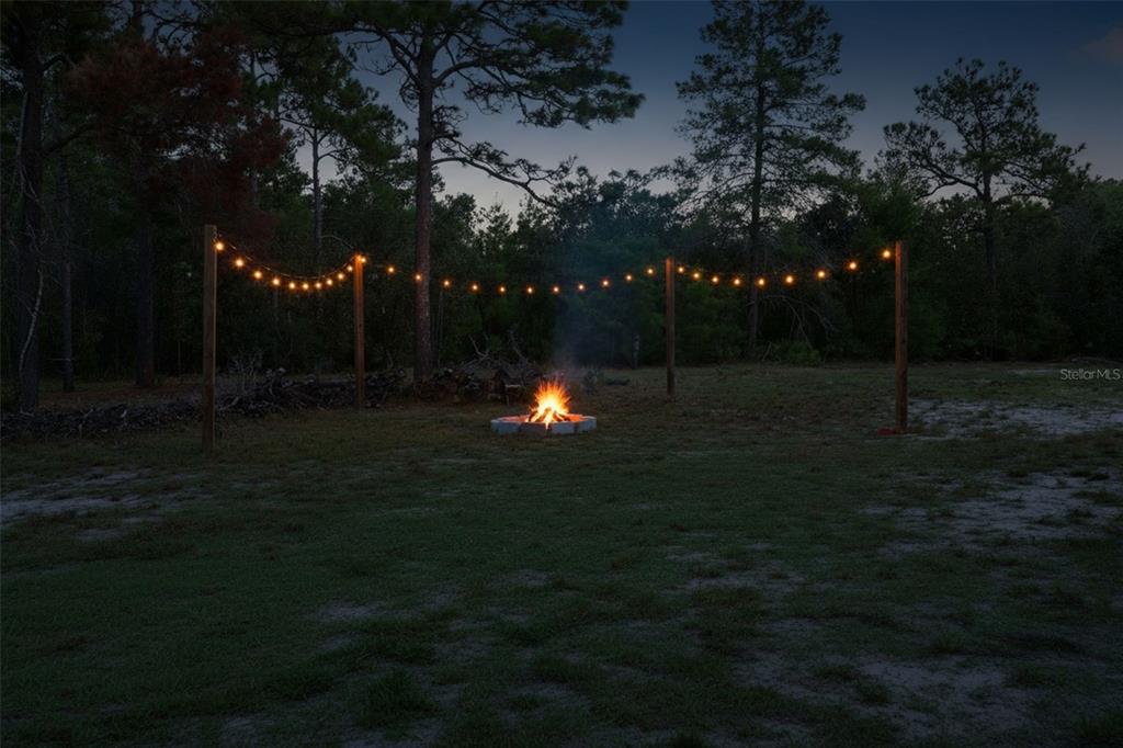 18166 Ramsey Road Weeki Wachee, FL 34614 - Photo 57 of 57 a backyard of house with lots of green space and trees