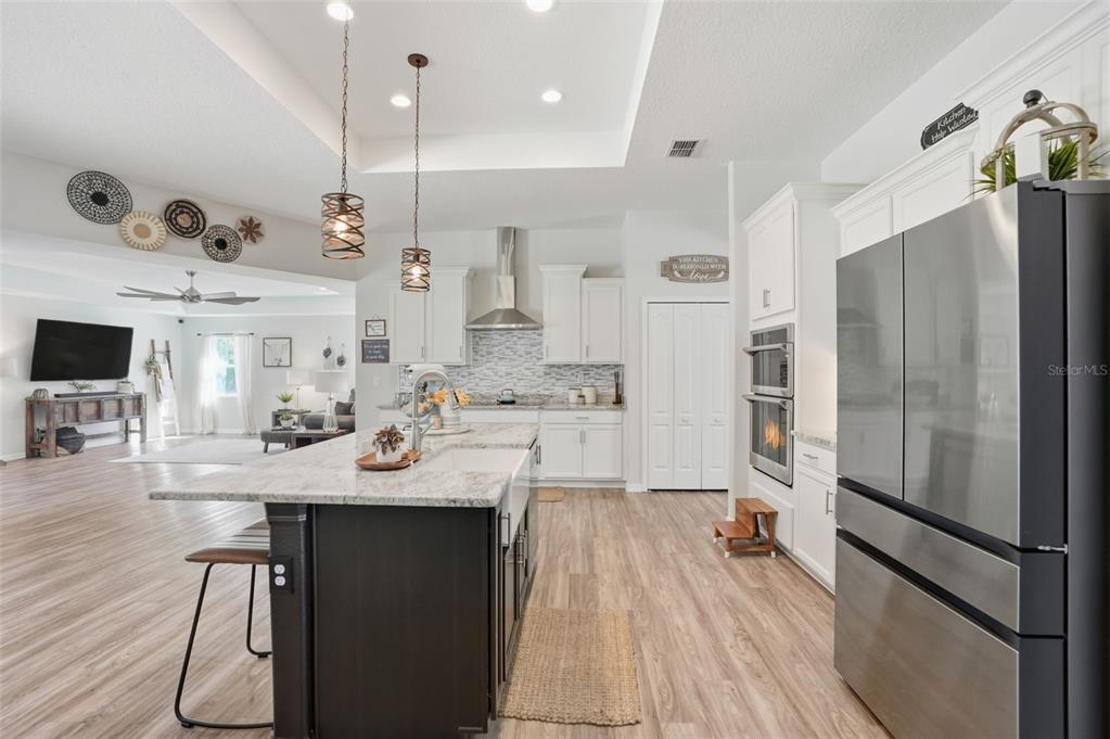 18166 Ramsey Road Weeki Wachee, FL 34614 - Photo 7 of 57 a kitchen with kitchen island a counter top space a sink stainless steel appliances and cabinets