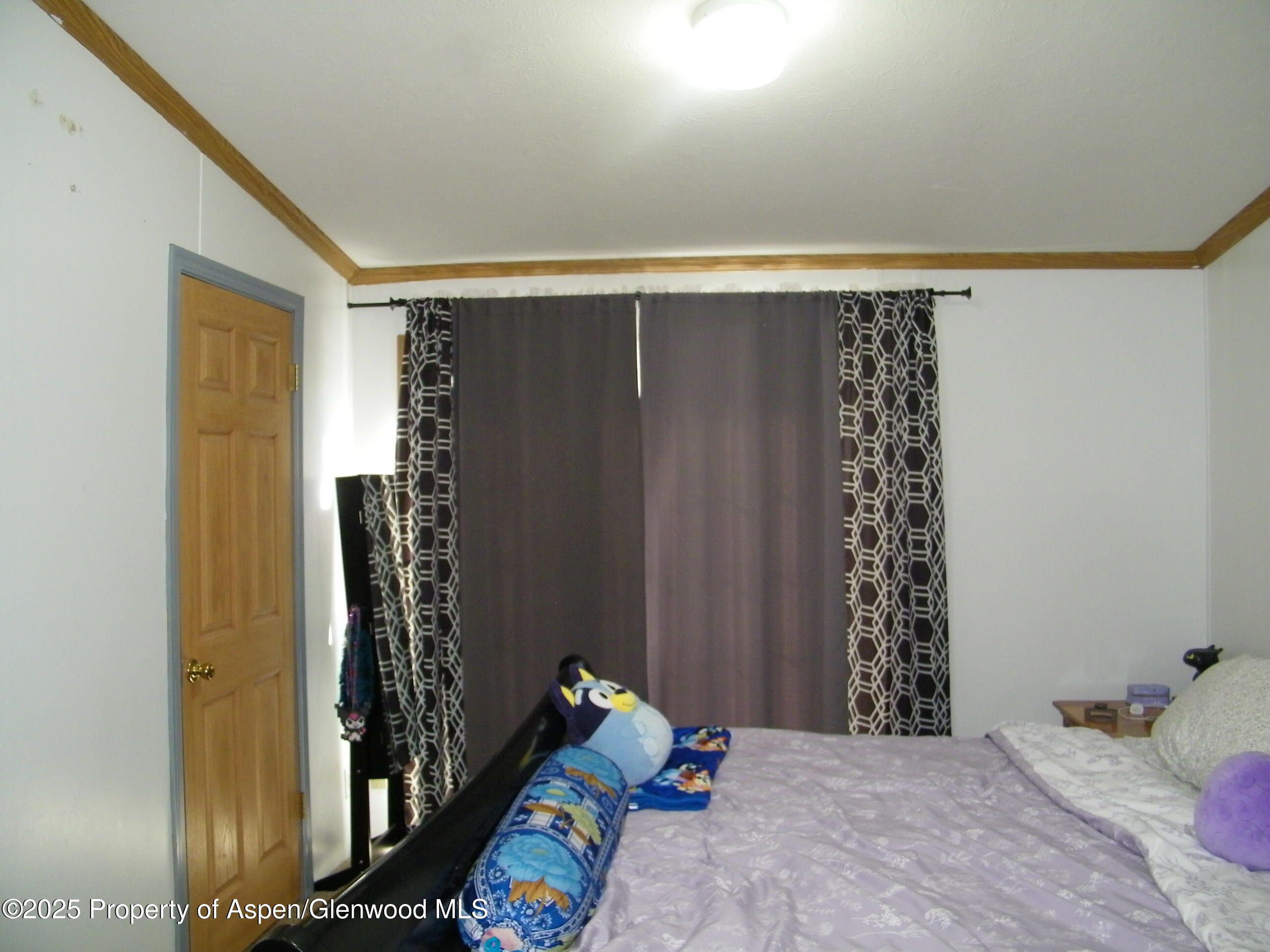 531 Park Avenue Rifle, CO 81650 - Photo 12 of 27 a bedroom with a bed and a window