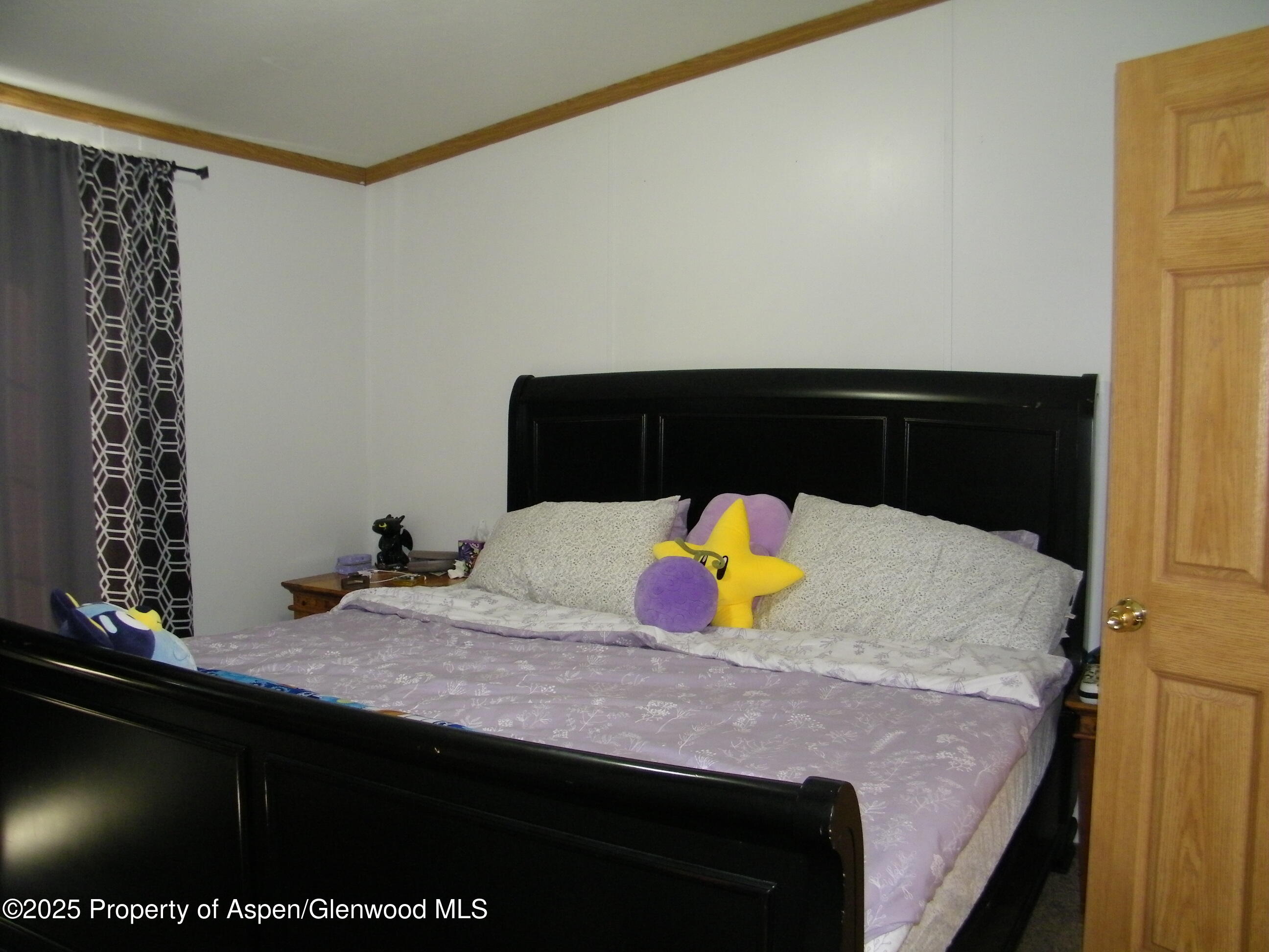 531 Park Avenue Rifle, CO 81650 - Photo 13 of 27 a bedroom with a bed and a dresser