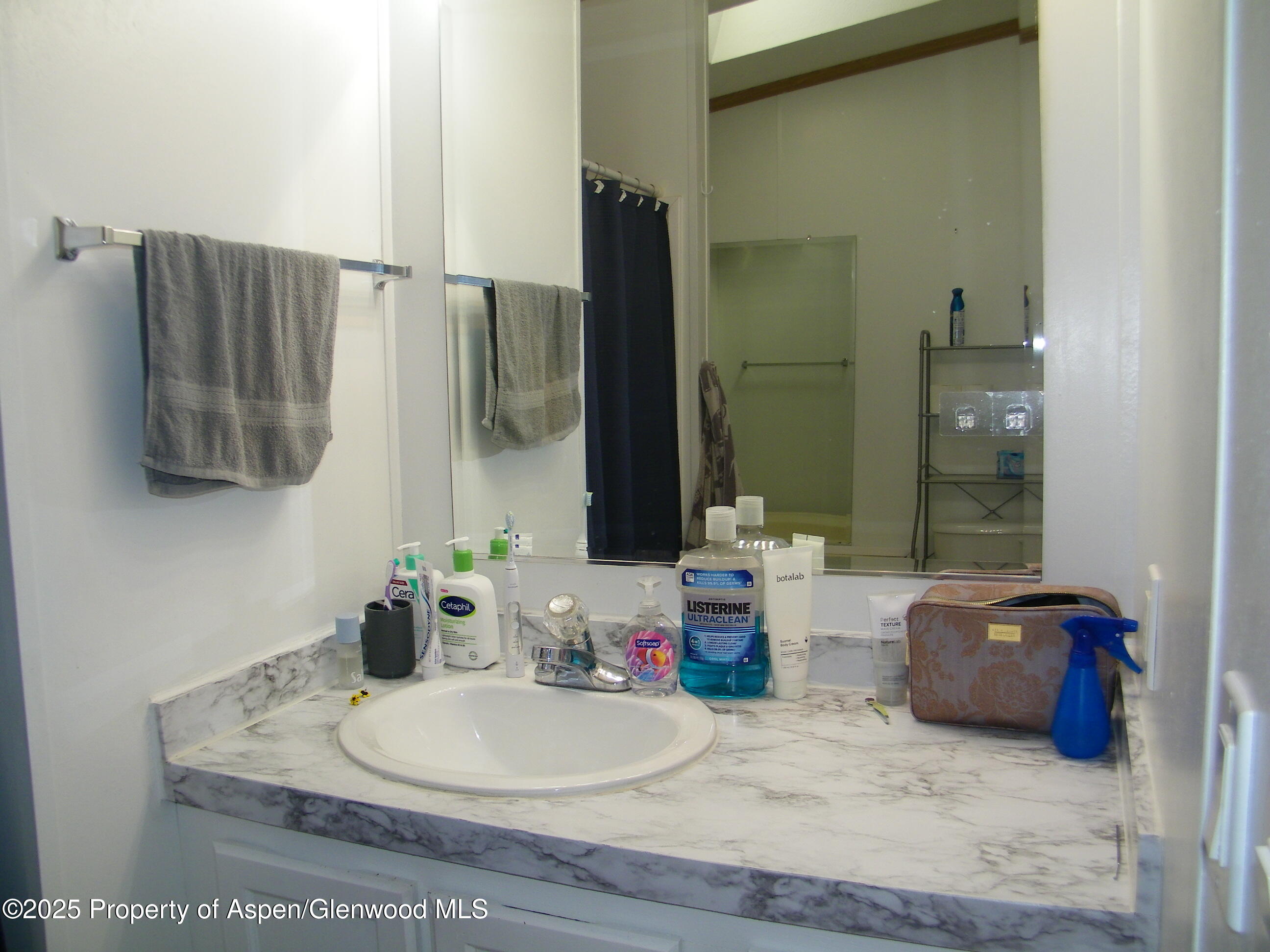 531 Park Avenue Rifle, CO 81650 - Photo 15 of 27 a bathroom with a sink and a mirror