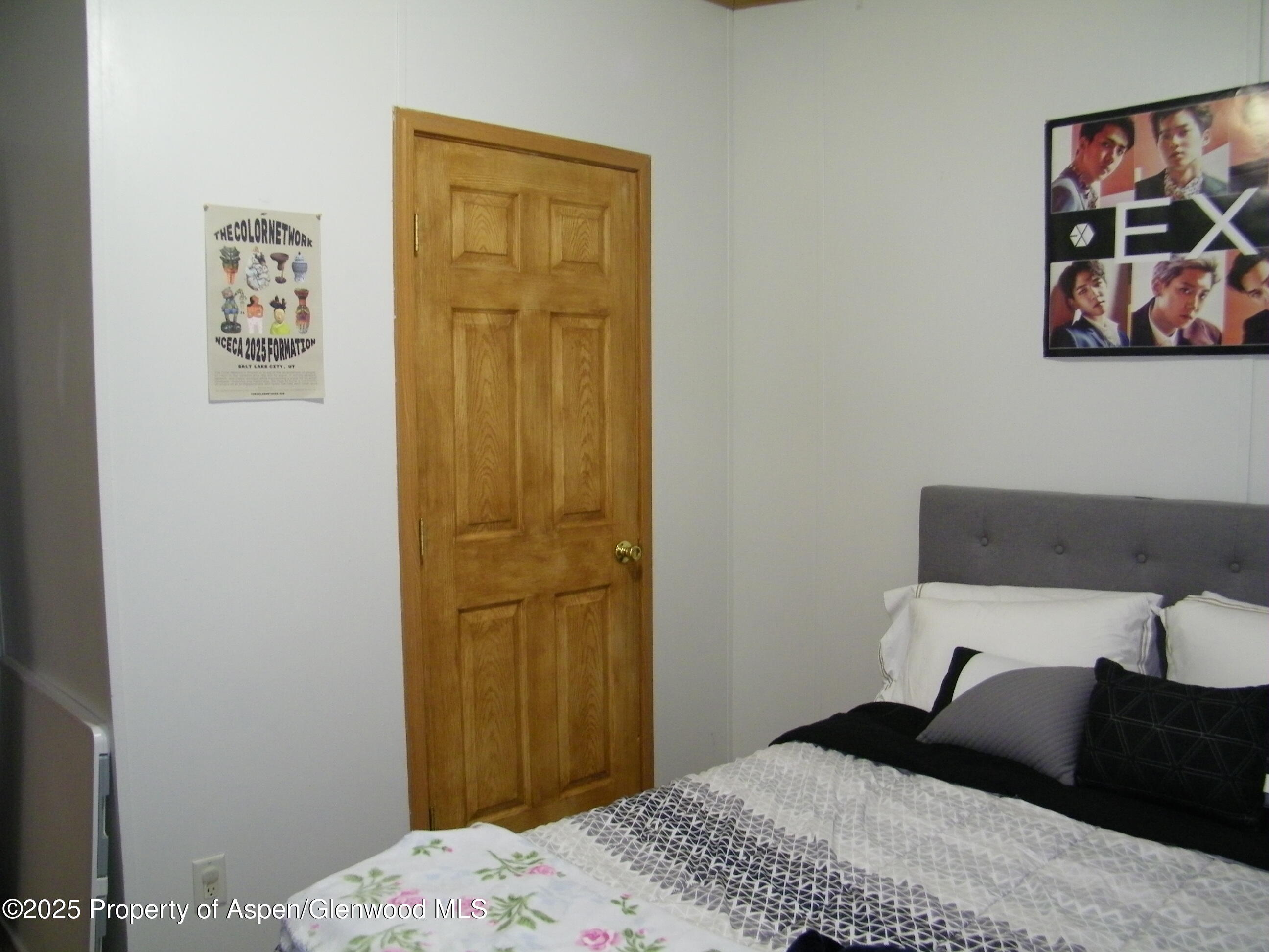 531 Park Avenue Rifle, CO 81650 - Photo 16 of 27 a bedroom with a bed and wall painting
