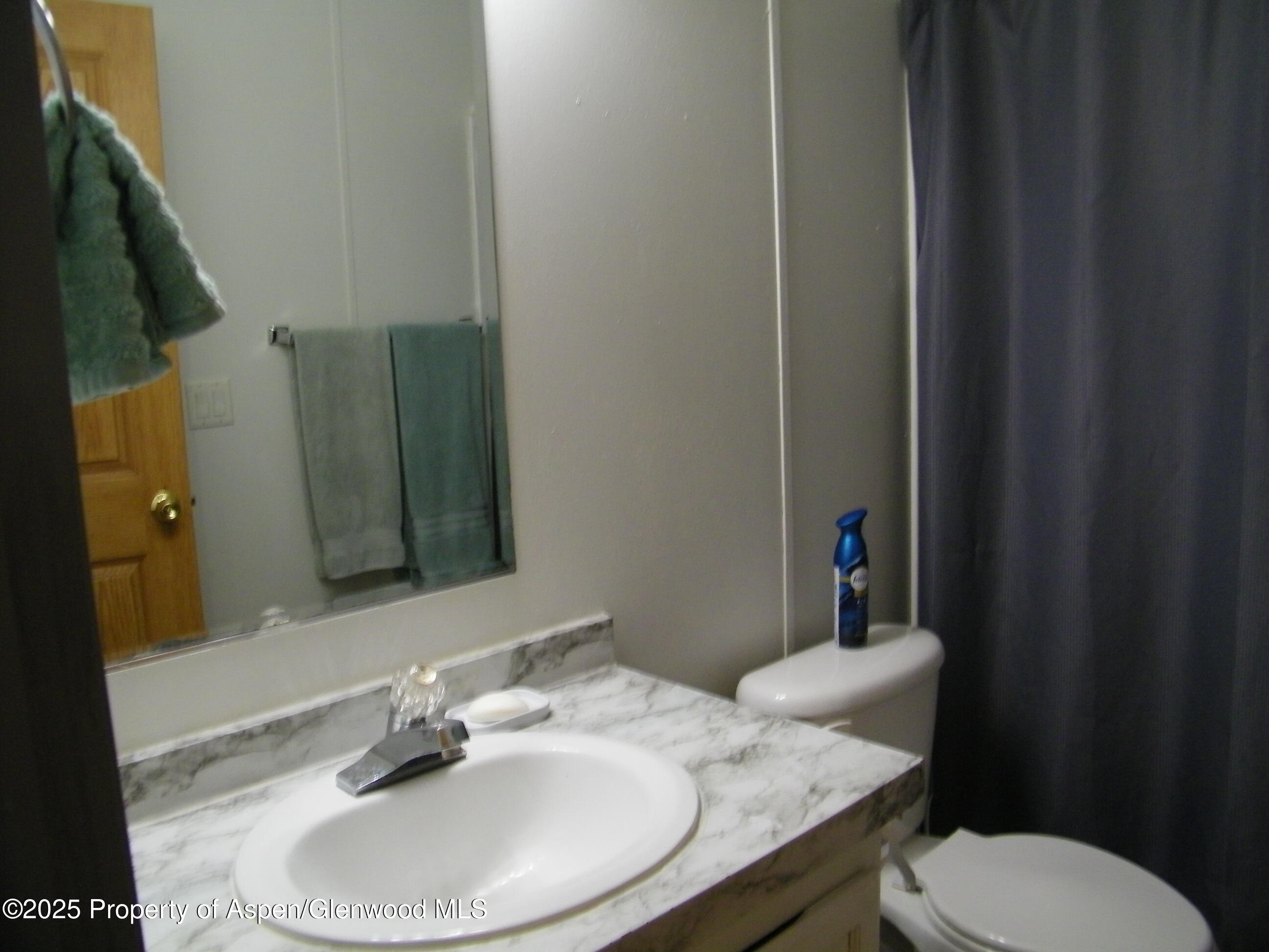 531 Park Avenue Rifle, CO 81650 - Photo 18 of 27 a bathroom with a granite countertop sink and a mirror