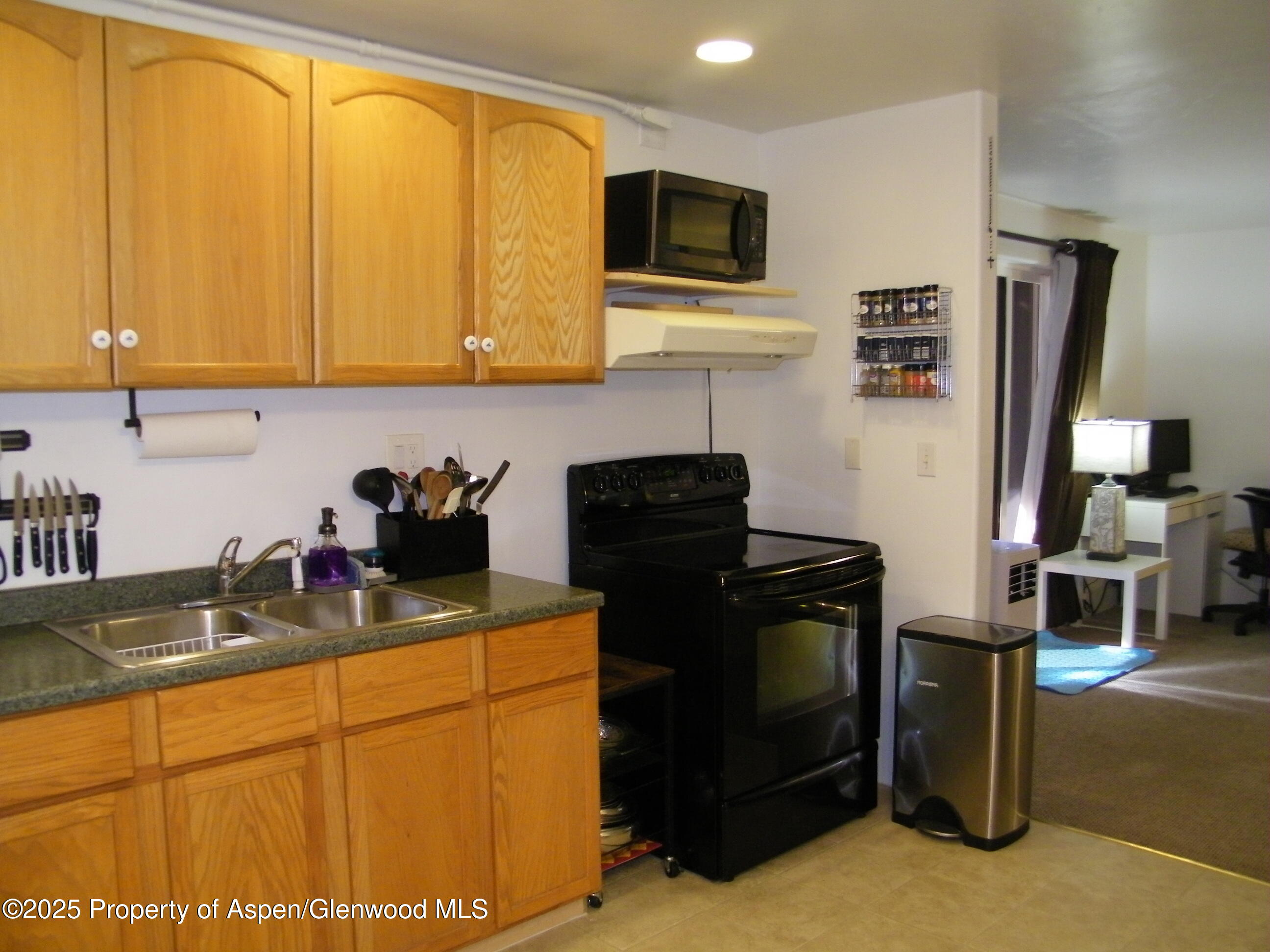 531 Park Avenue Rifle, CO 81650 - Photo 23 of 27 a kitchen with stainless steel appliances granite countertop a sink stove and refrigerator