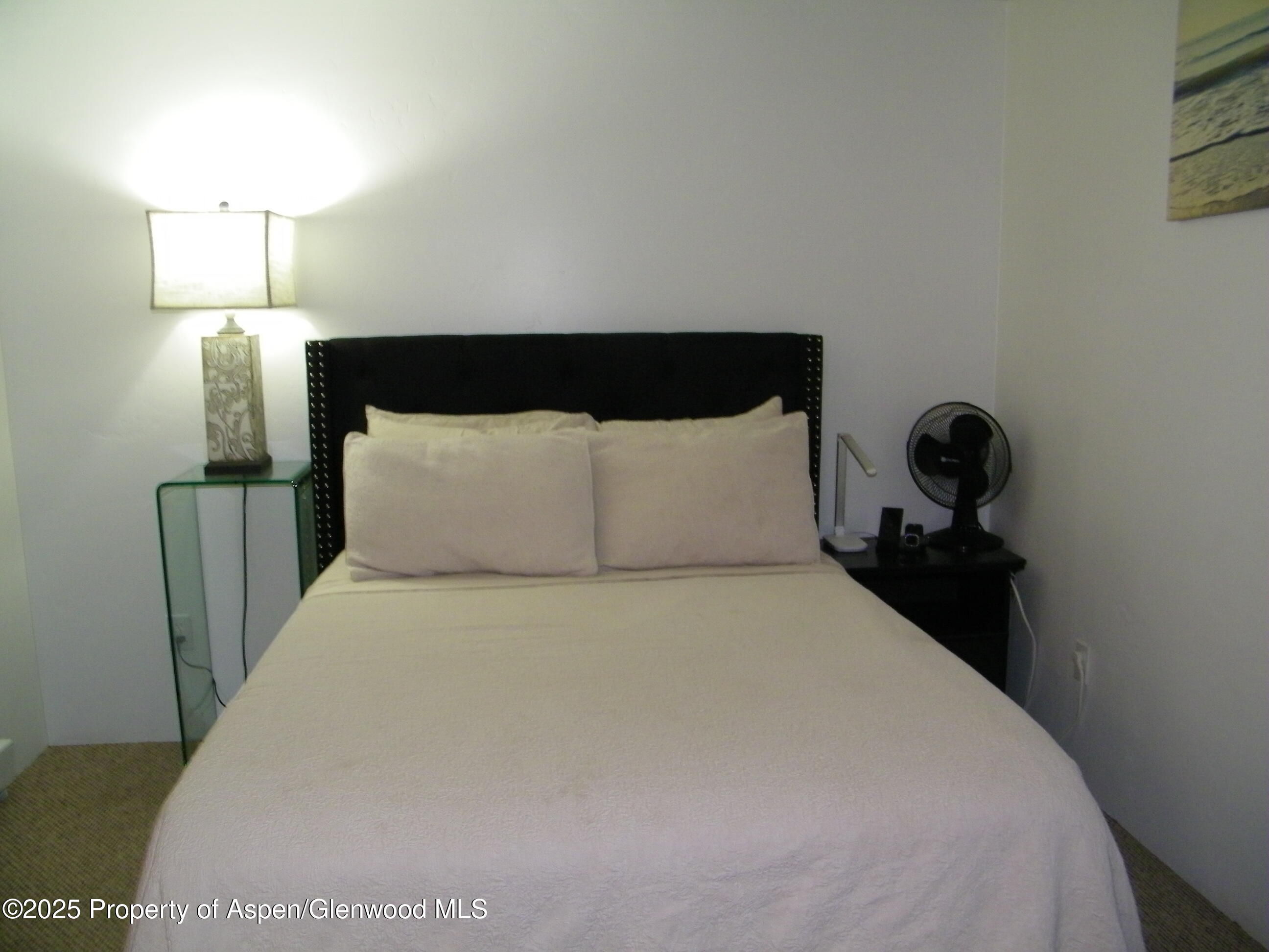 531 Park Avenue Rifle, CO 81650 - Photo 25 of 27 a large bed sitting in a bedroom next to a lamp