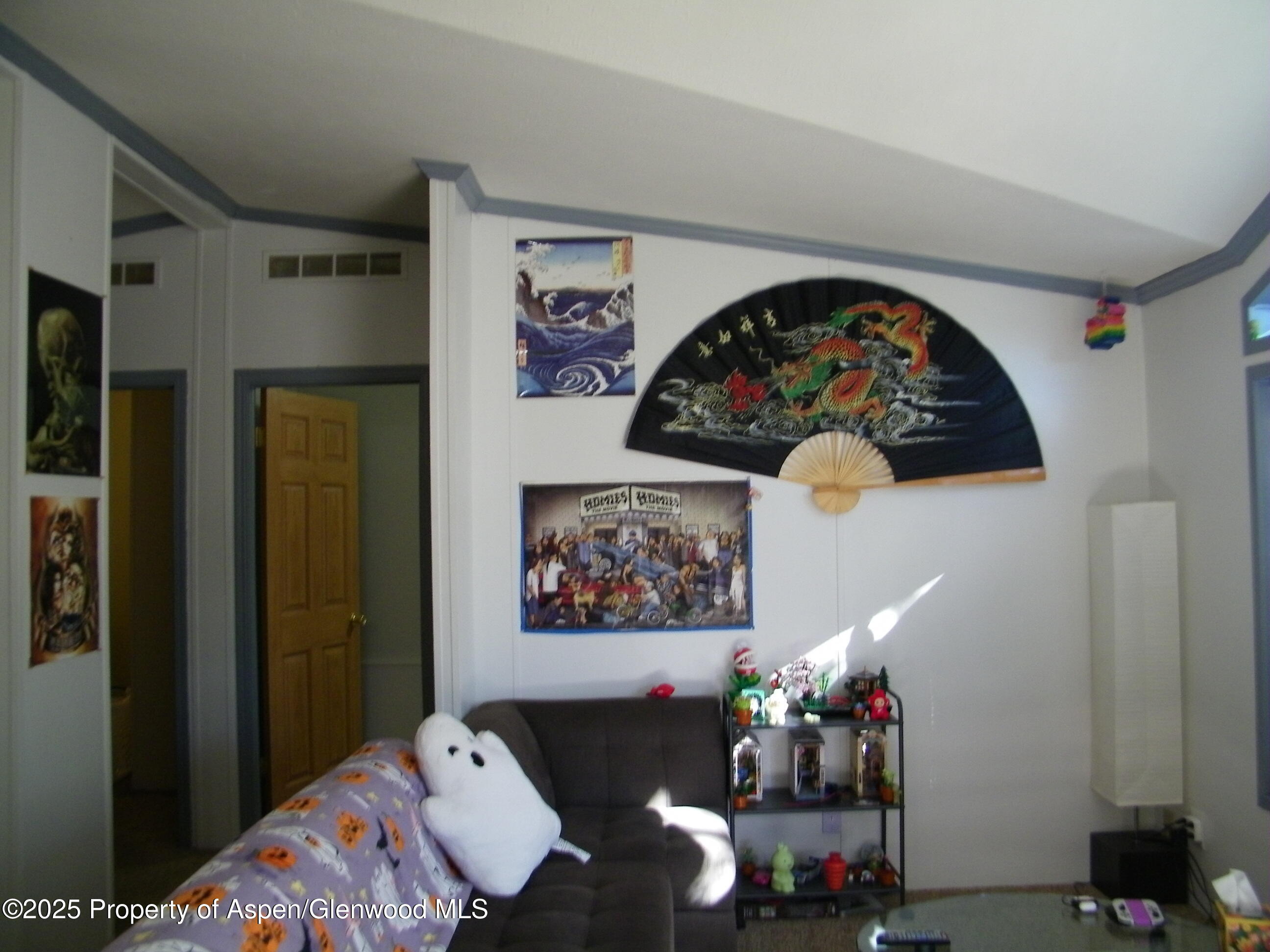 531 Park Avenue Rifle, CO 81650 - Photo 6 of 27 a bed room with a bed a couch and painting on the wall
