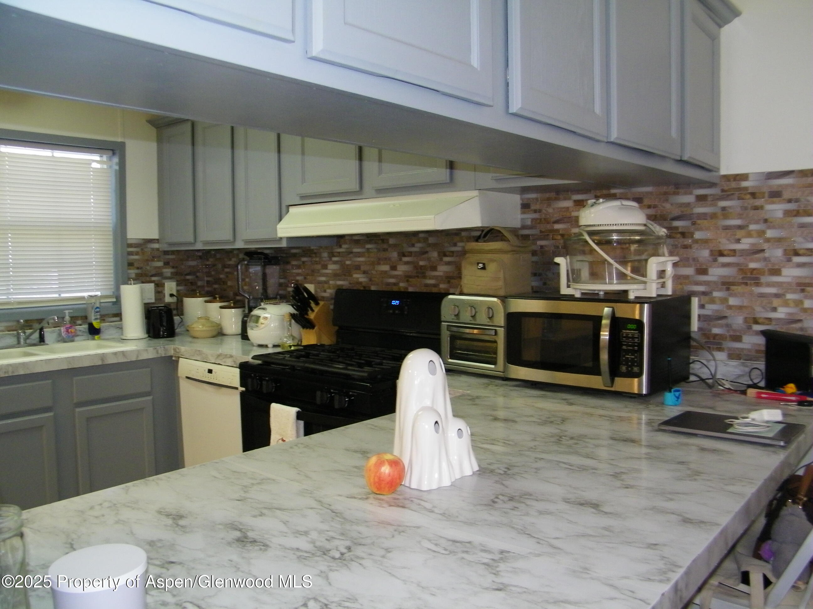 531 Park Avenue Rifle, CO 81650 - Photo 7 of 27 a kitchen with a sink and a stove