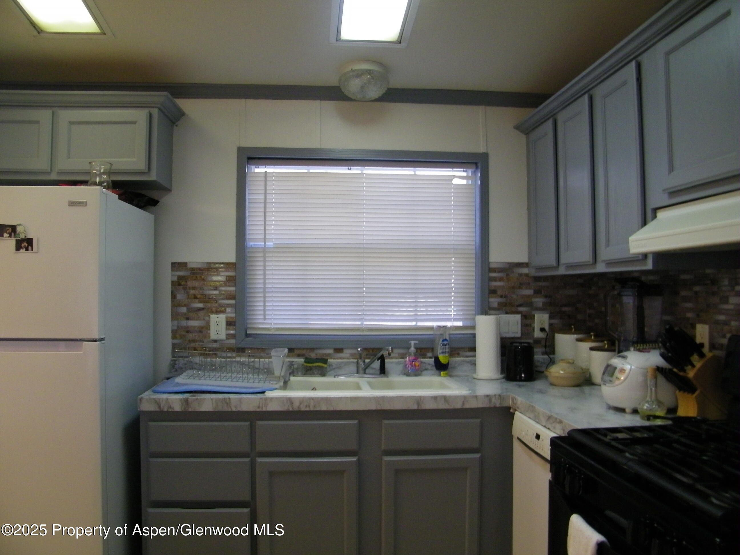 531 Park Avenue Rifle, CO 81650 - Photo 8 of 27 a kitchen with a sink cabinets and appliances