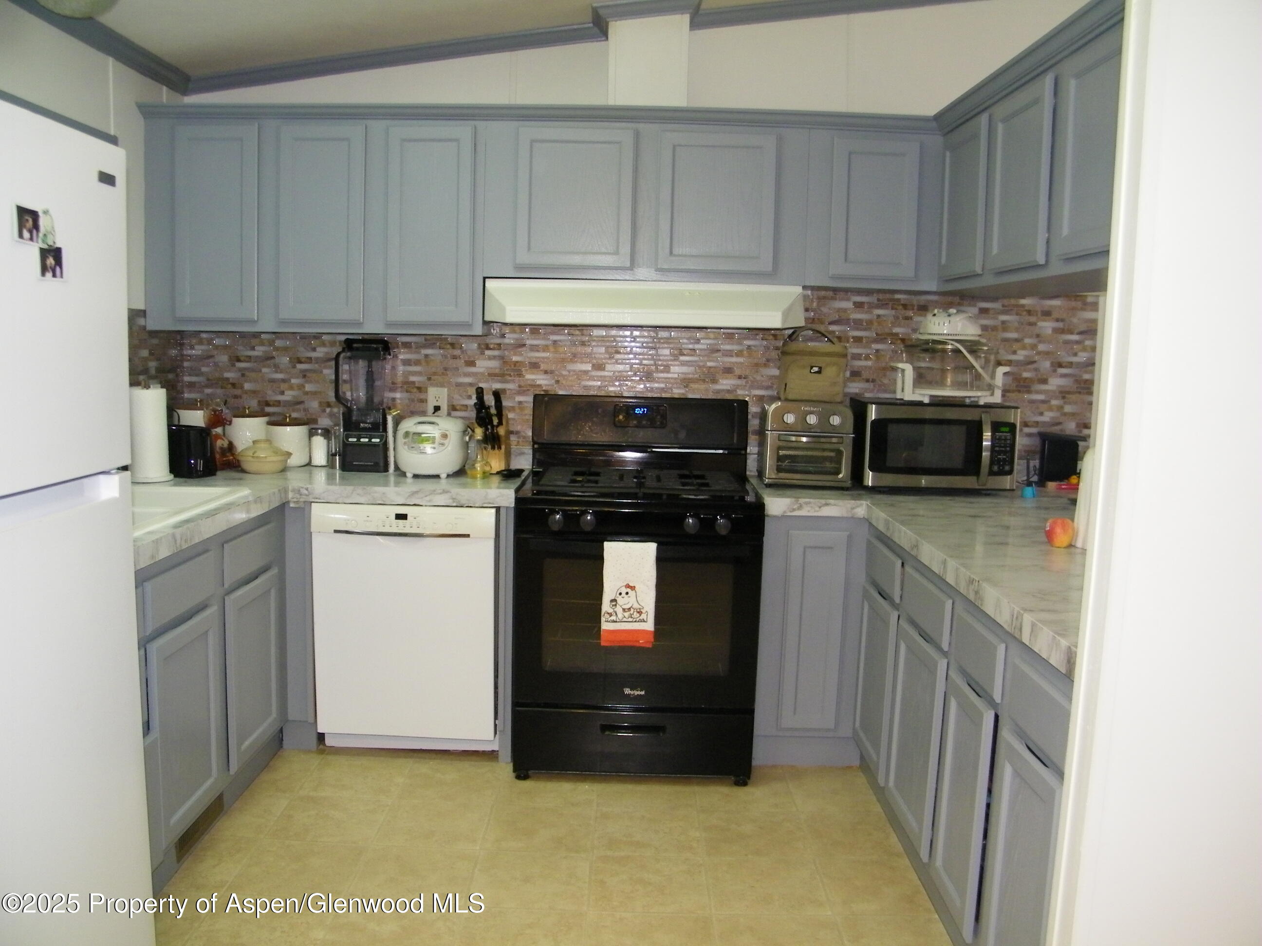 531 Park Avenue Rifle, CO 81650 - Photo 9 of 27 a kitchen with a stove top oven and cabinets