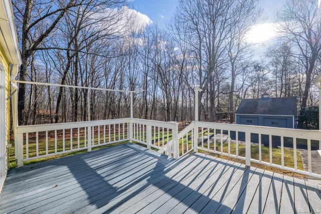 a view of a wooden deck with a yard and wooden fence