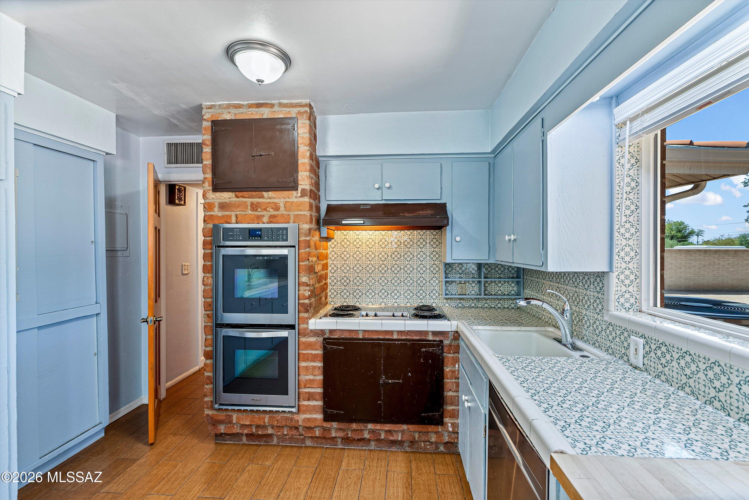 2107 East Lind Road Tucson, AZ 85719 - Photo 15 of 43 a kitchen with a stove a sink and a refrigerator