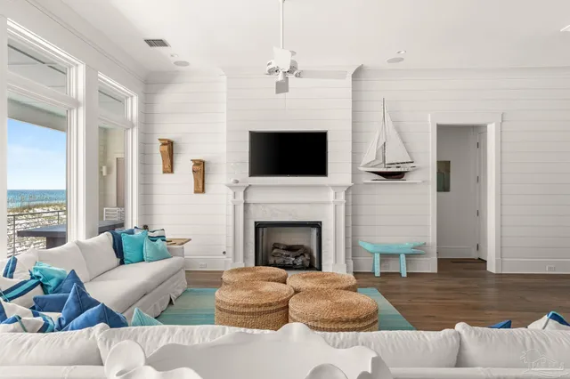 a living room with furniture a fireplace and a flat screen tv