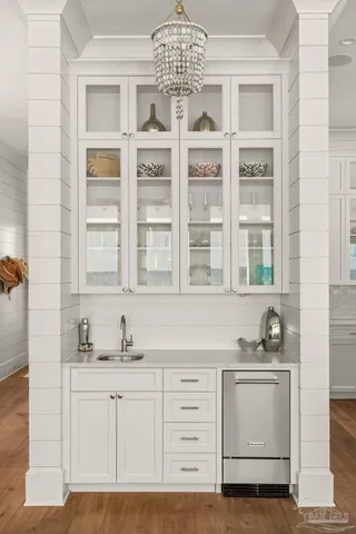 a view of a dining room with furniture and chandelier