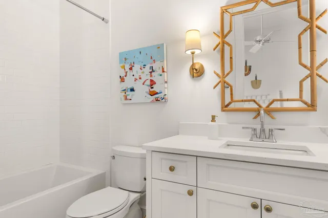 a bathroom with a shower sink vanity mirror and toilet