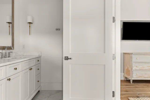 a view of a hallway with wooden floor and furniture