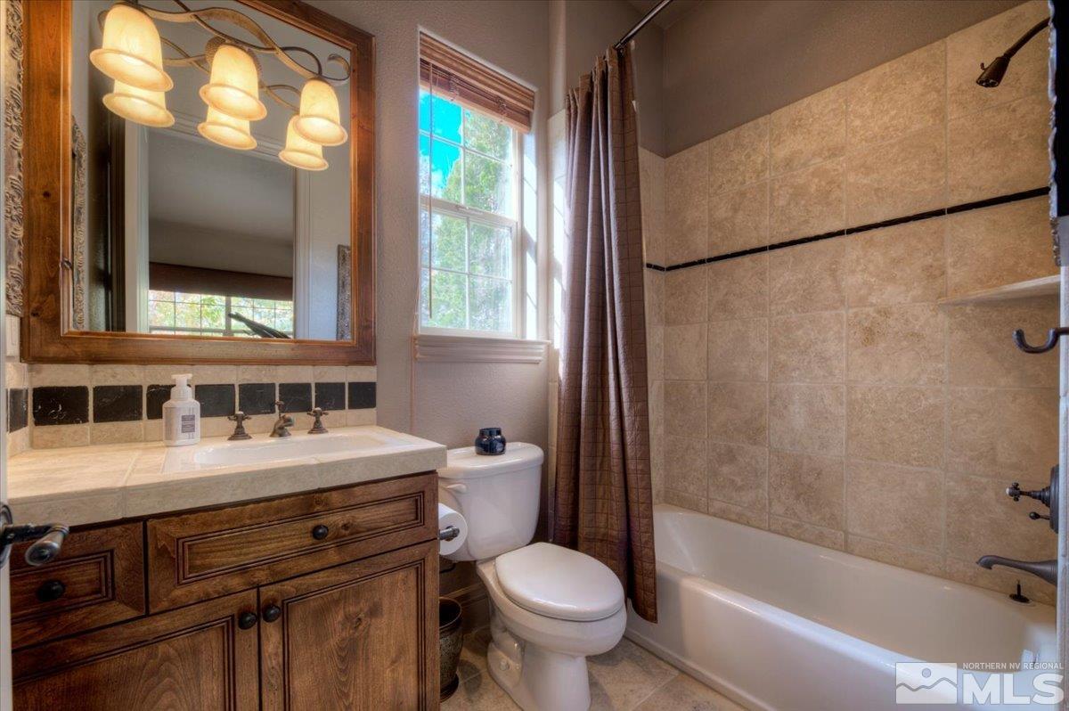 1318 Wolf Run Road Reno, NV 89511 - Photo 23 of 37 a bathroom with a sink toilet and shower