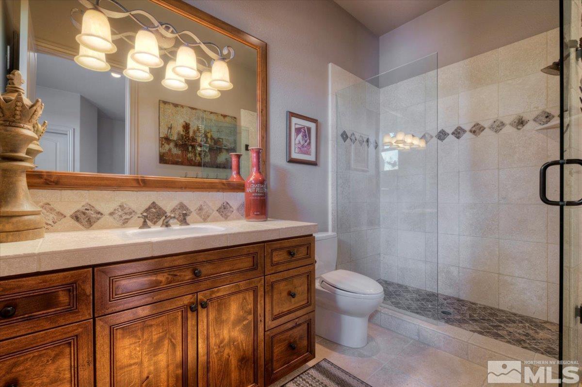 1318 Wolf Run Road Reno, NV 89511 - Photo 25 of 37 a bathroom with a sink a toilet and shower