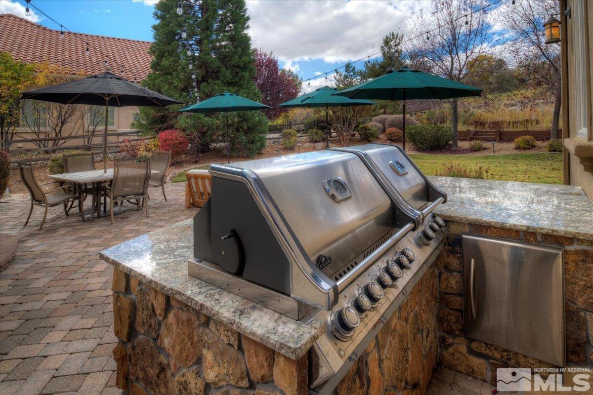 1318 Wolf Run Road Reno, NV 89511 - Photo 29 of 37 a view of a patio with chairs under an umbrella