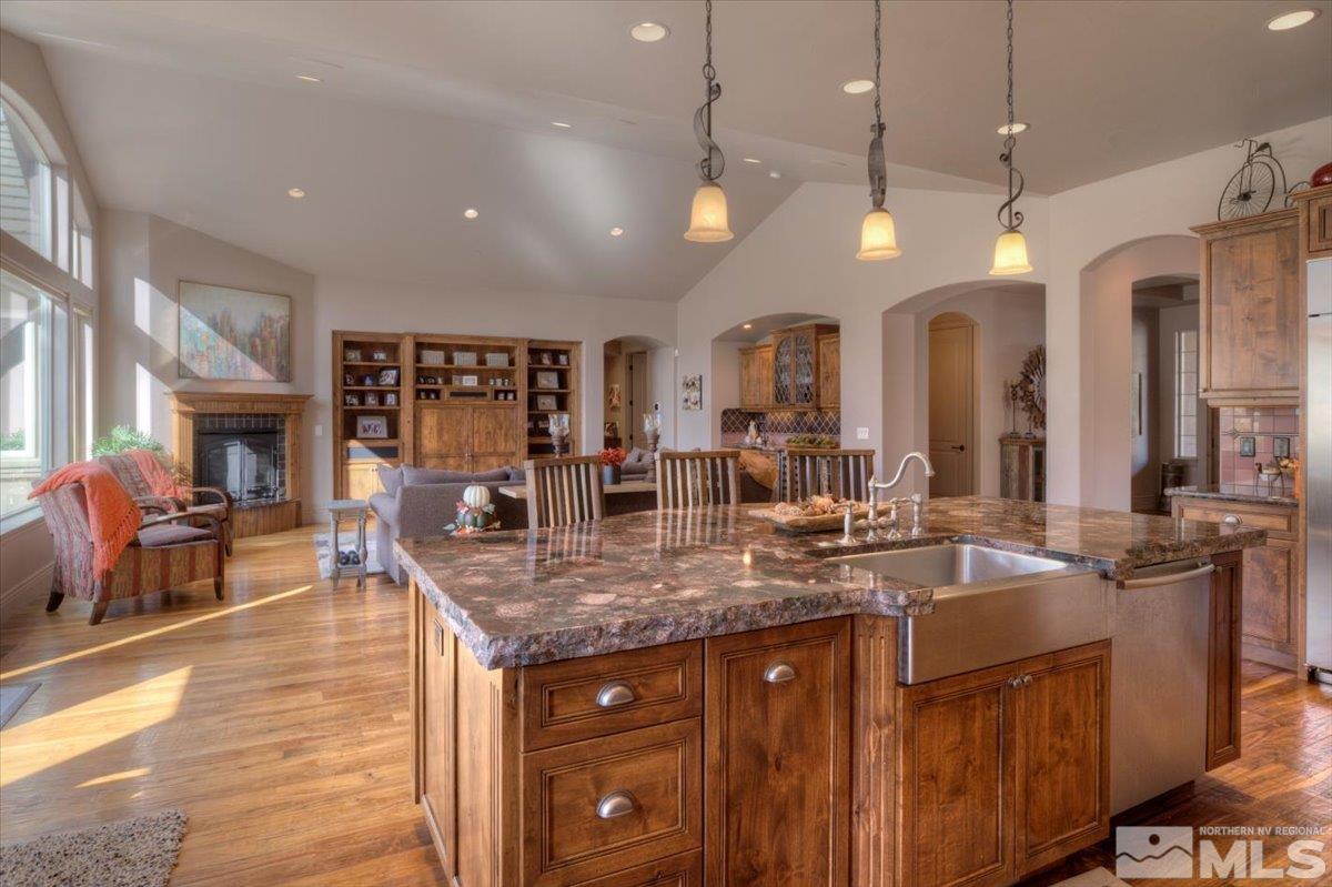1318 Wolf Run Road Reno, NV 89511 - Photo 8 of 37 a kitchen with granite countertop a stove a sink a oven a dining table and chairs