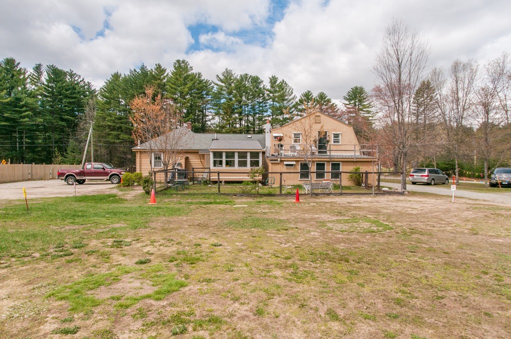 451 Silver Lake Road Hollis, NH 03049 - Photo 5 of 29 a aerial view of residential houses with yard and trees in the background