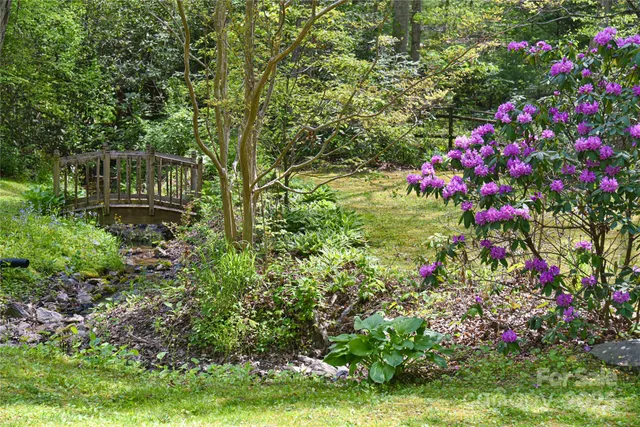 a large kitchen with stainless steel appliances kitchen island granite countertop a sink and cabinets