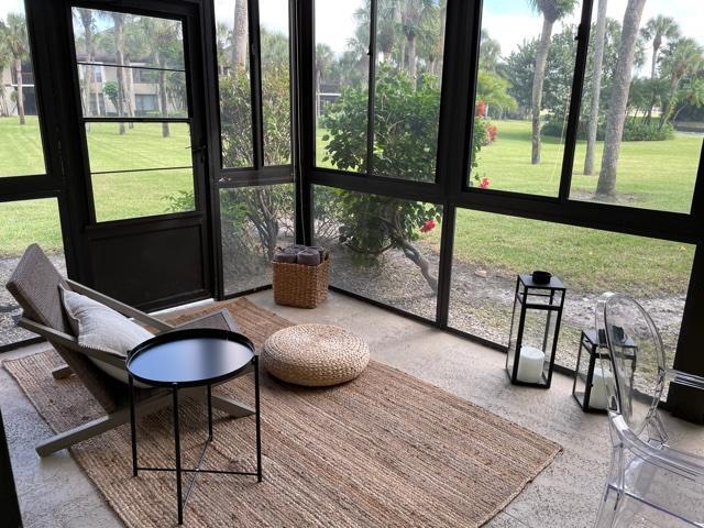 13400 Polo Road West Wellington, FL 33414 - Photo 4 of 16 a living room with patio furniture and a floor to ceiling window
