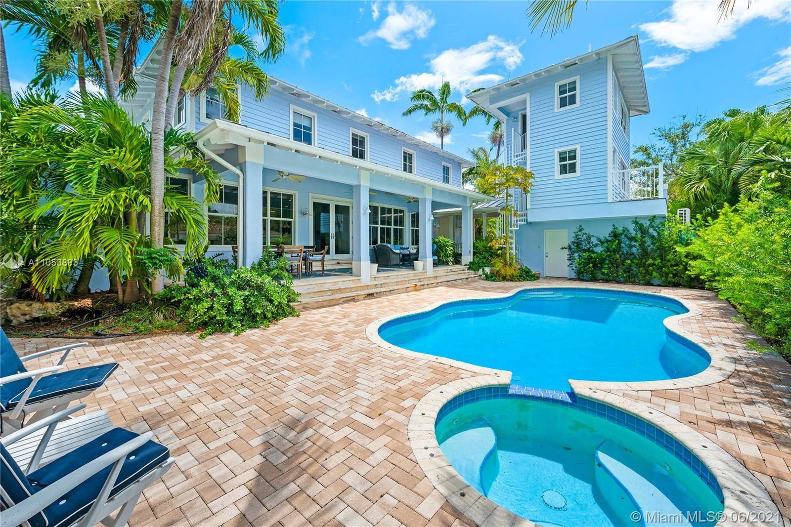 280 Woodcrest Road Key Biscayne, FL 33149 - Photo 2 of 41 a view of a swimming pool with an outdoor seating