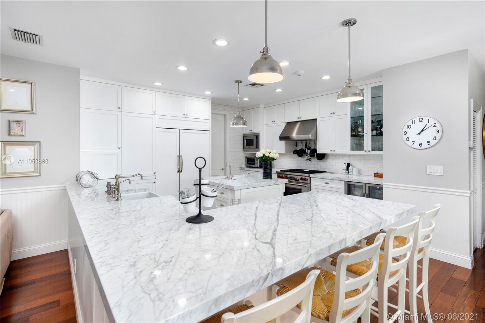 280 Woodcrest Road Key Biscayne, FL 33149 - Photo 11 of 41 a kitchen with granite countertop a sink a counter top space appliances and cabinets