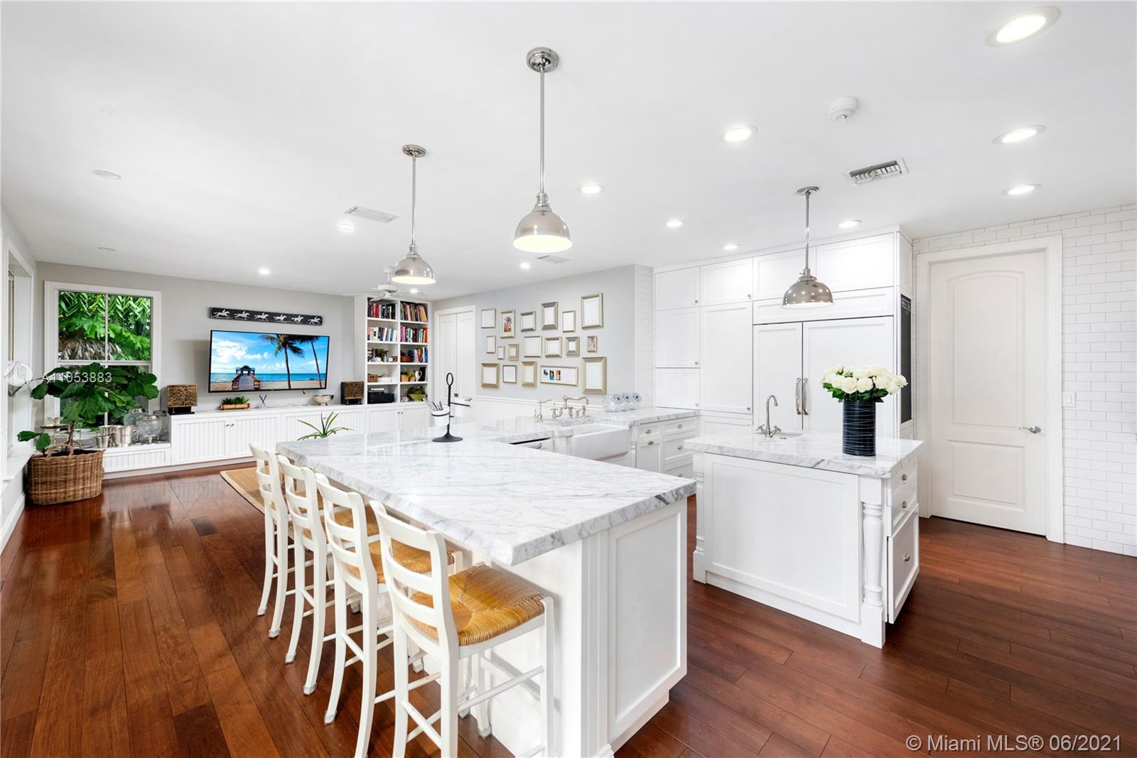 280 Woodcrest Road Key Biscayne, FL 33149 - Photo 12 of 41 a large kitchen with kitchen island a large island in it