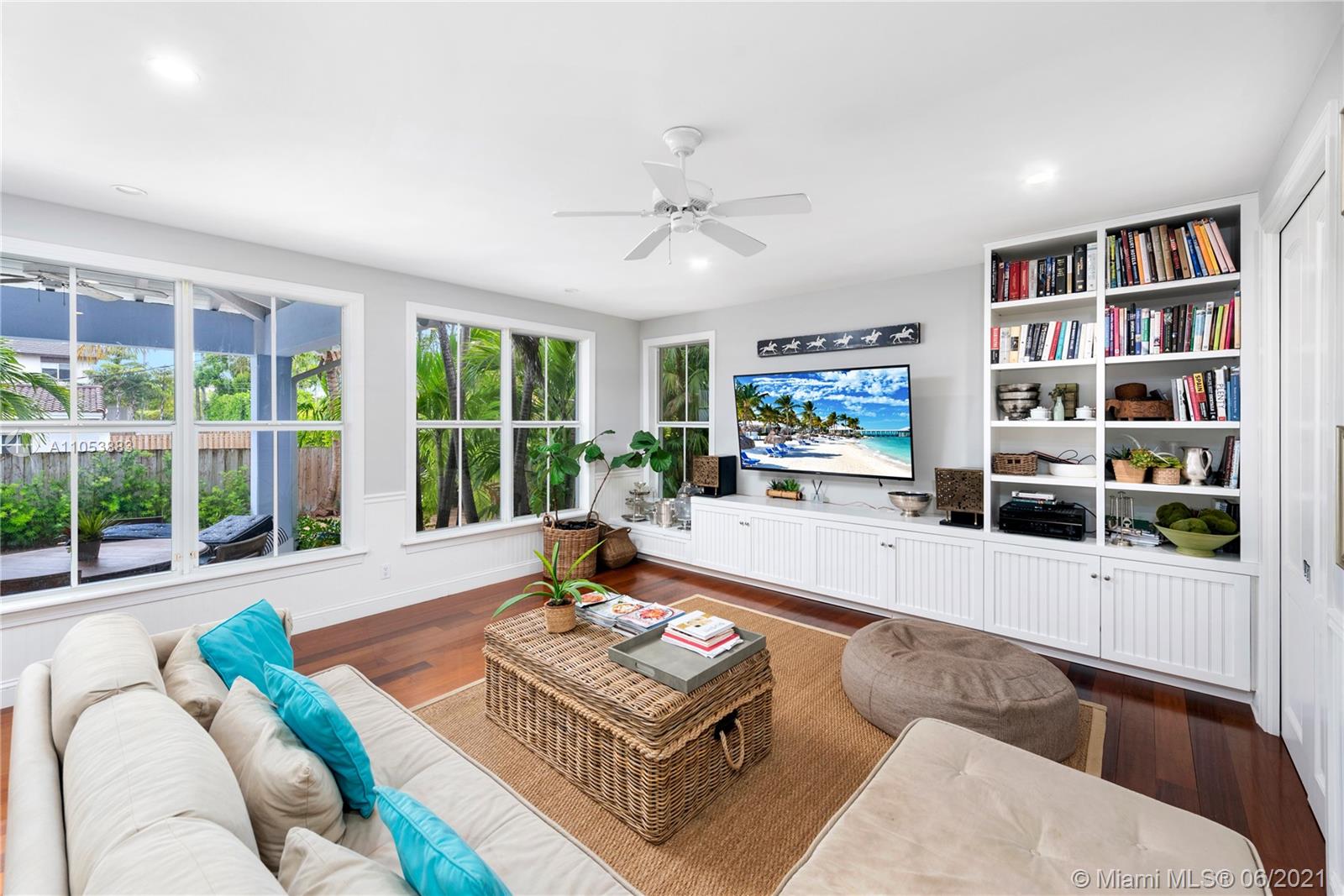 280 Woodcrest Road Key Biscayne, FL 33149 - Photo 14 of 41 a living room with furniture and a book shelf