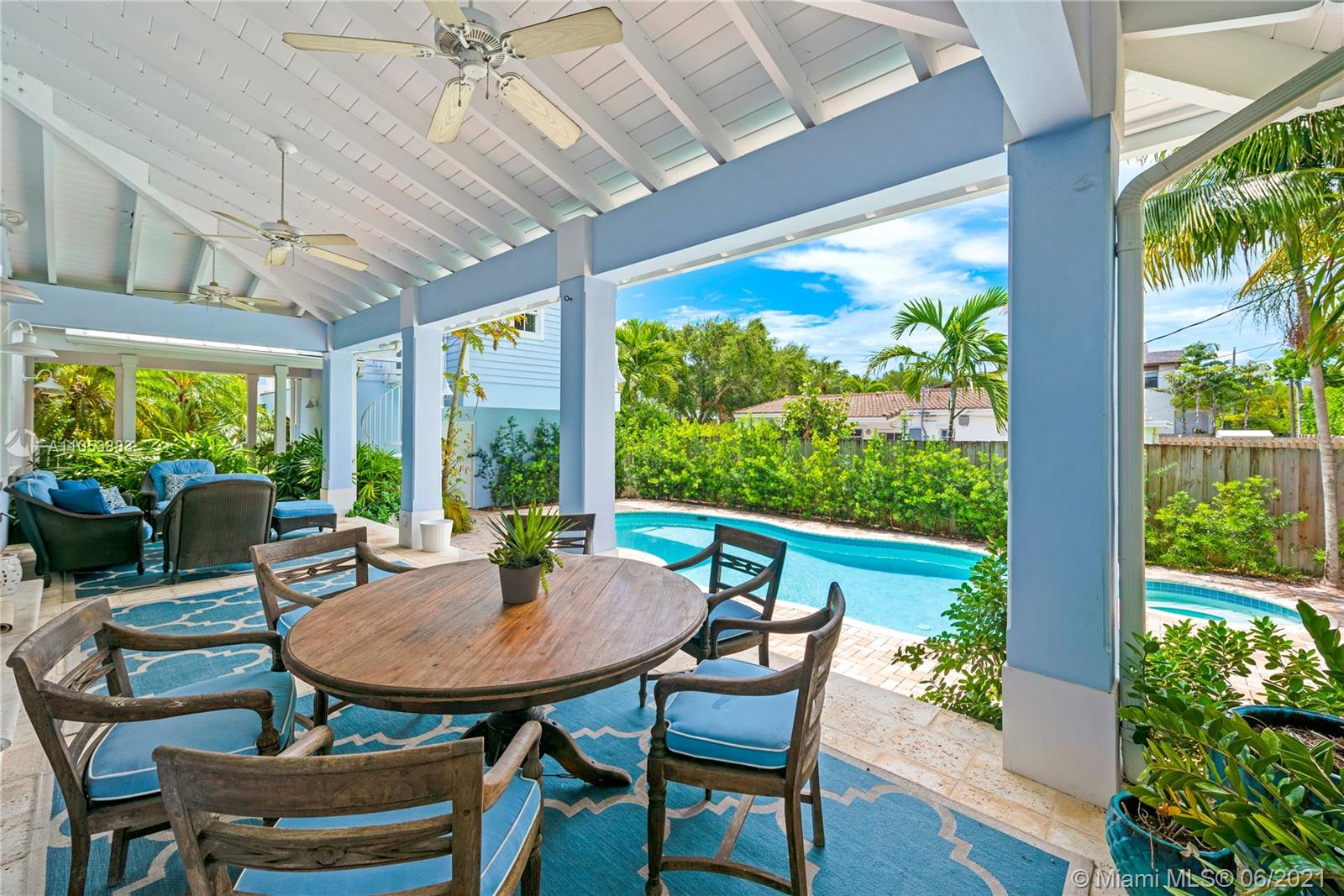 280 Woodcrest Road Key Biscayne, FL 33149 - Photo 18 of 41 a view of a patio with a table chairs and a table