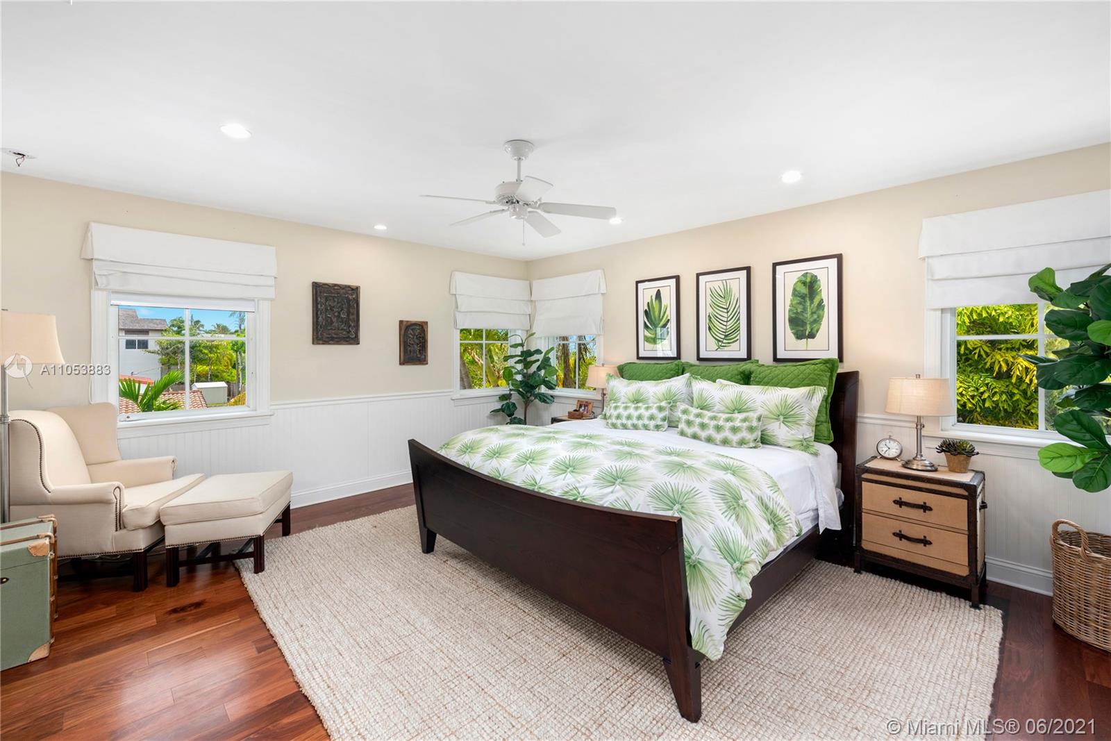 280 Woodcrest Road Key Biscayne, FL 33149 - Photo 21 of 41 a spacious bedroom with a bed a couch and a potted plant