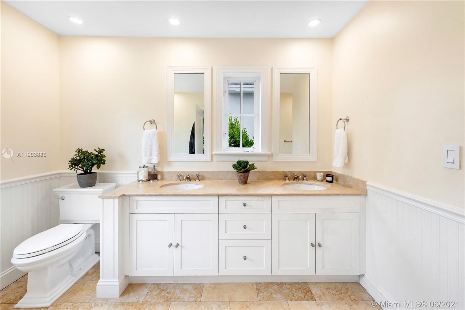 280 Woodcrest Road Key Biscayne, FL 33149 - Photo 24 of 41 a bathroom with a granite countertop sink mirror vanity and toilet