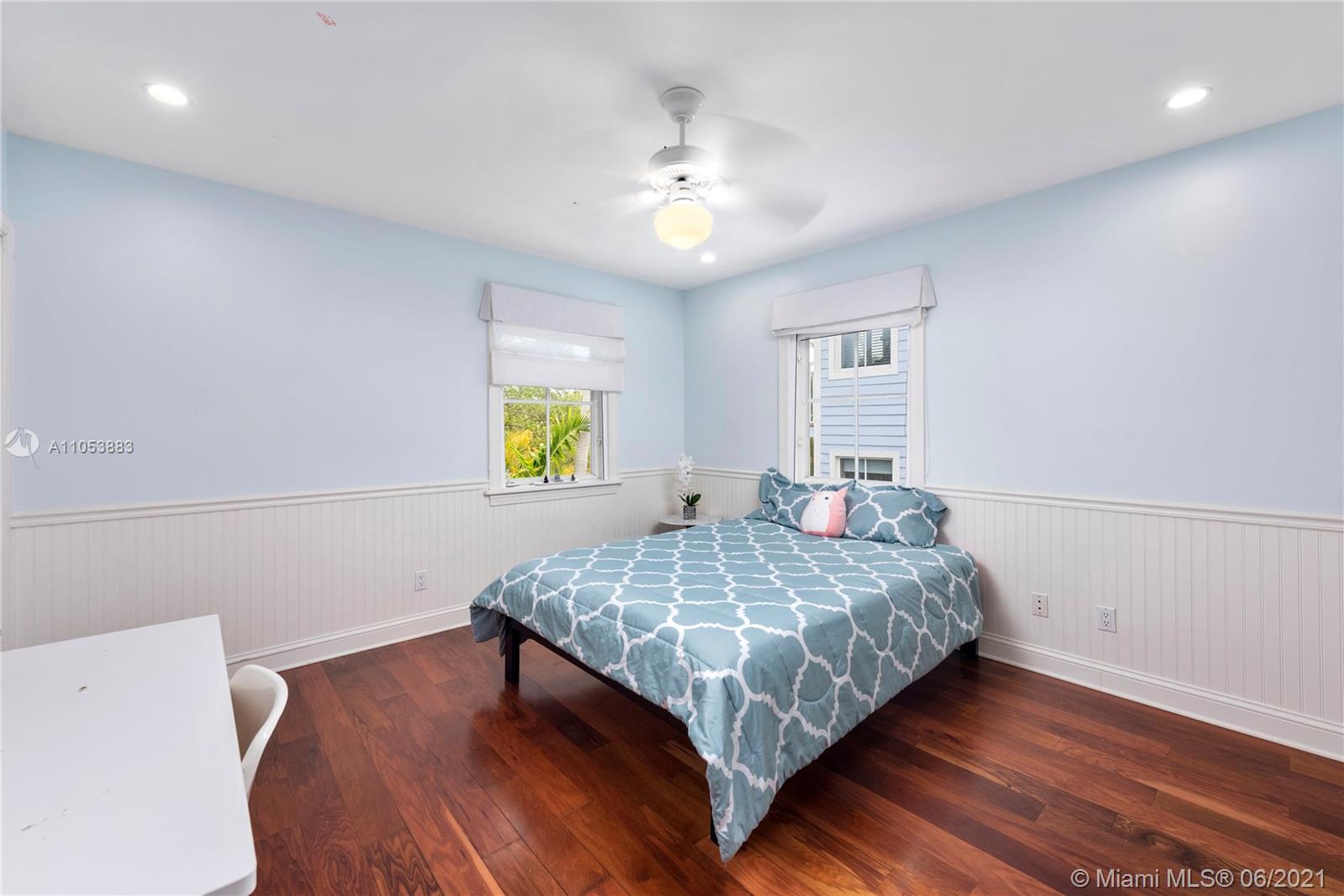 280 Woodcrest Road Key Biscayne, FL 33149 - Photo 26 of 41 a bedroom with a bed and a chandelier