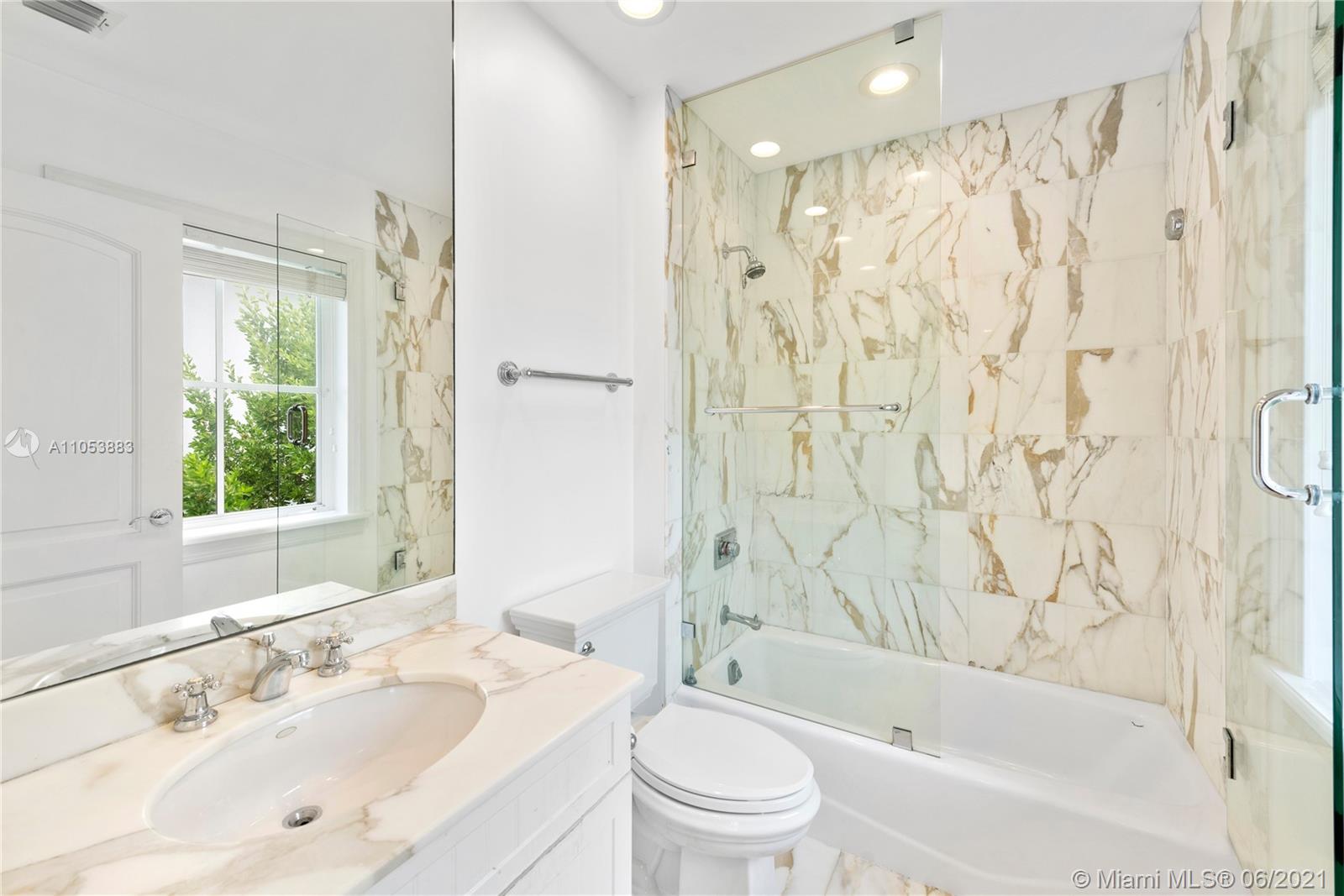 280 Woodcrest Road Key Biscayne, FL 33149 - Photo 31 of 41 a bathroom with a bathtub shower sink vanity mirror and toilet