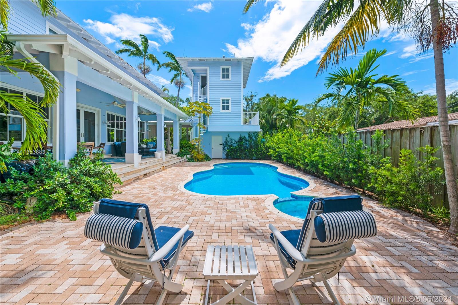 280 Woodcrest Road Key Biscayne, FL 33149 - Photo 32 of 41 a view of a patio with couches table and chairs potted plants and palm trees