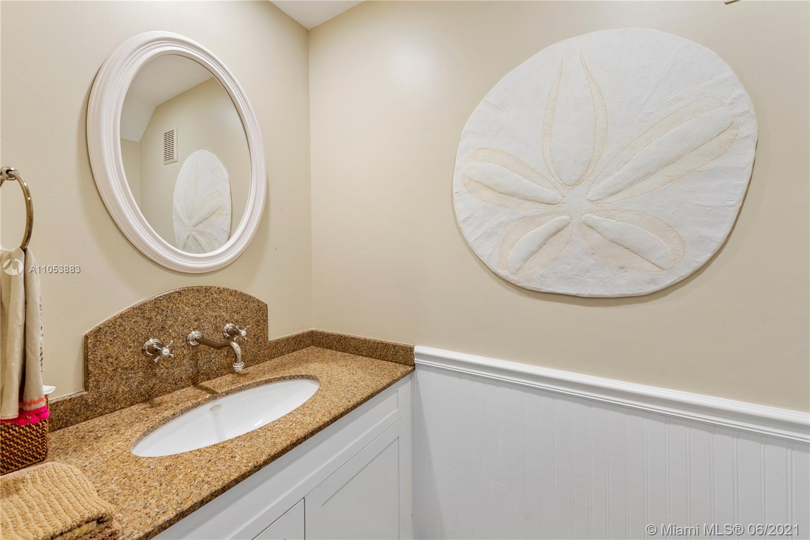 280 Woodcrest Road Key Biscayne, FL 33149 - Photo 9 of 41 a bathroom with a granite countertop sink and a mirror