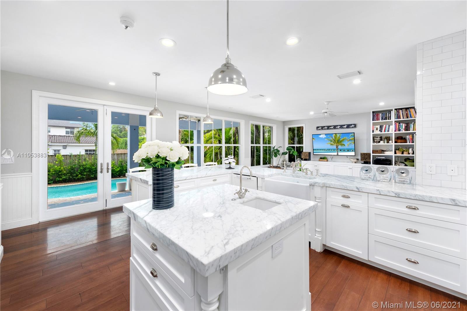 280 Woodcrest Road Key Biscayne, FL 33149 - Photo 10 of 41 a kitchen with stainless steel appliances granite countertop a stove and a wooden floors