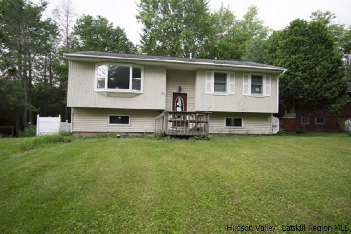 35 Aster Road Loch Sheldrake, NY 12759 - Photo 1 of 11 a front view of house with yard and trees in the background