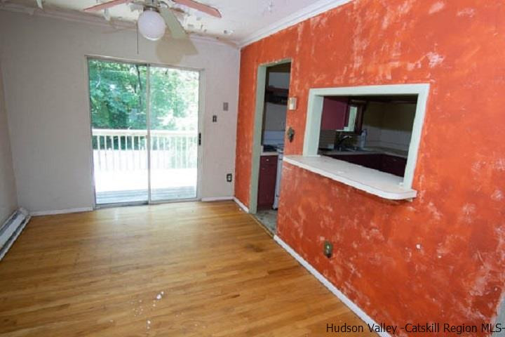 35 Aster Road Loch Sheldrake, NY 12759 - Photo 10 of 11 a view of a hallway with wooden floor and a fireplace