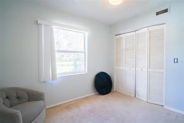 an empty room with windows and closet