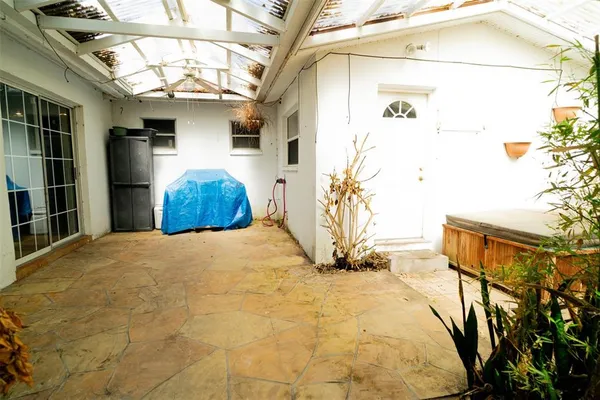 a view of a room with a chandelier and refrigerator
