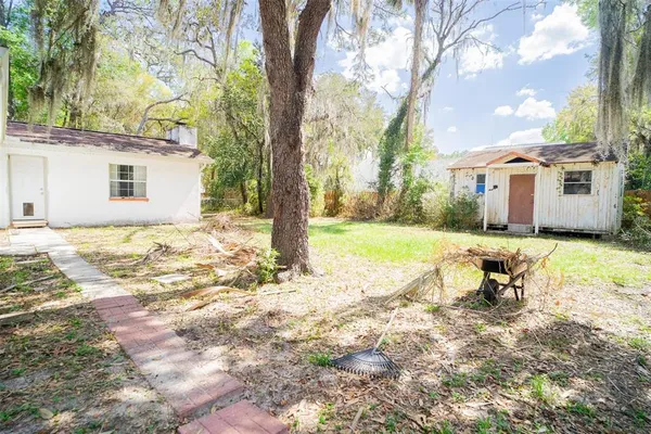 a backyard of a house with table and chairs